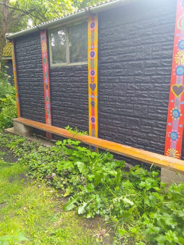 A scaffolding plank and breezeblock bench that seats 8 people.