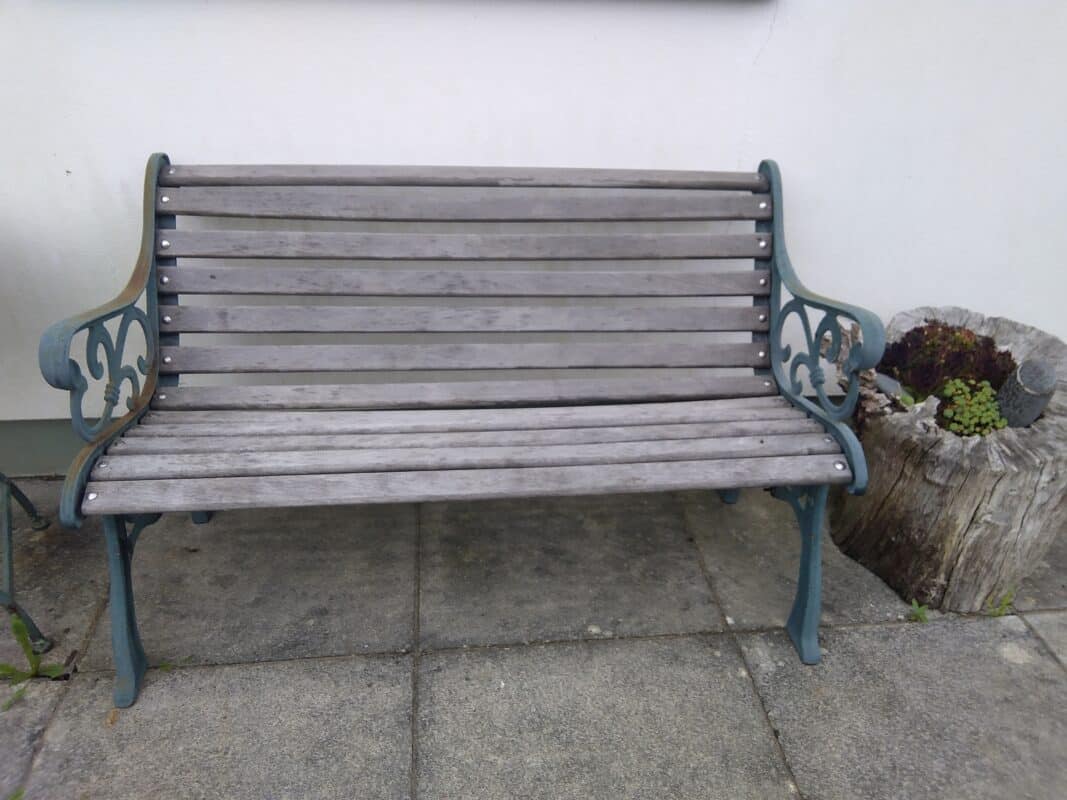 A new garden bench made from old cast iron park bench arms.