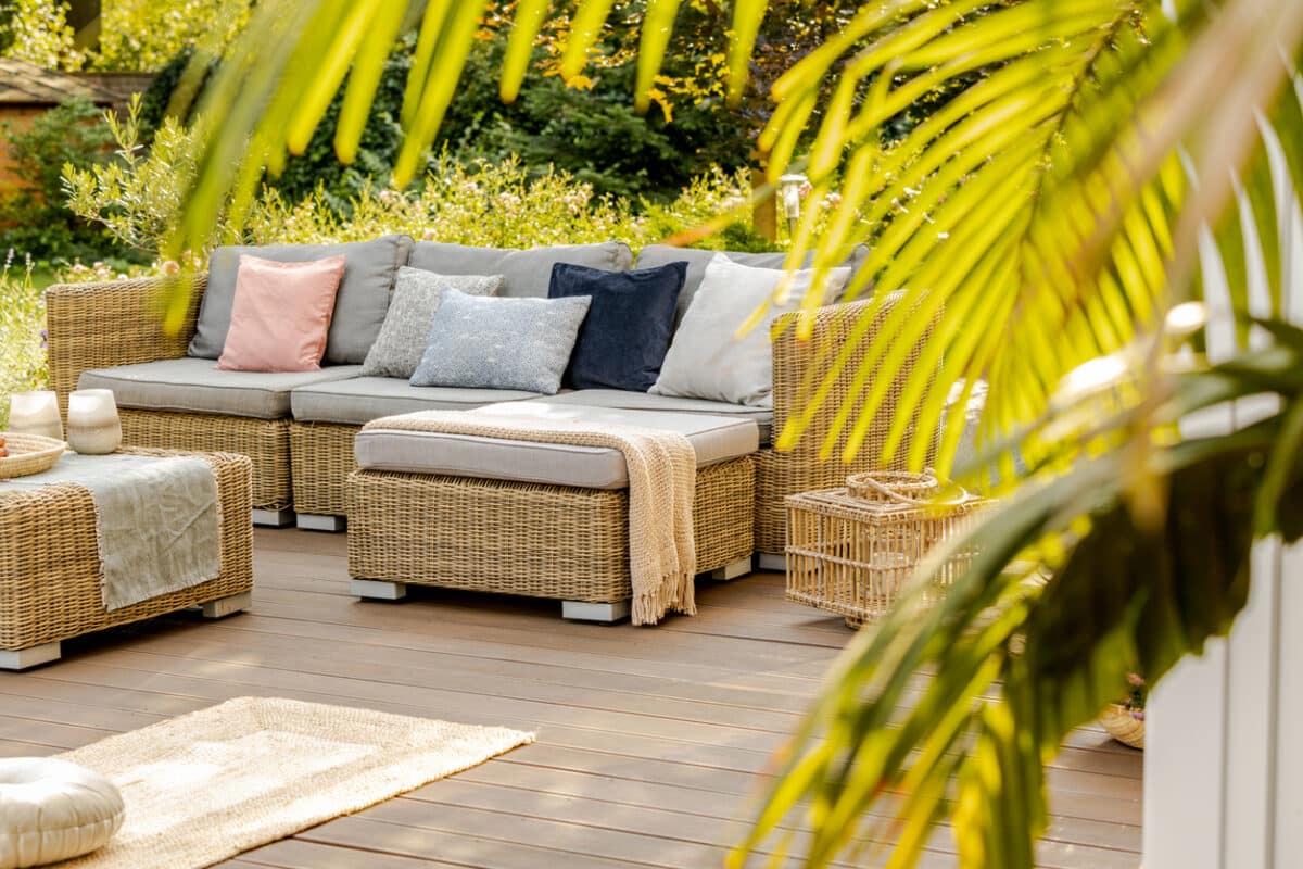 Rattan furniture on a wooden deck outdoors